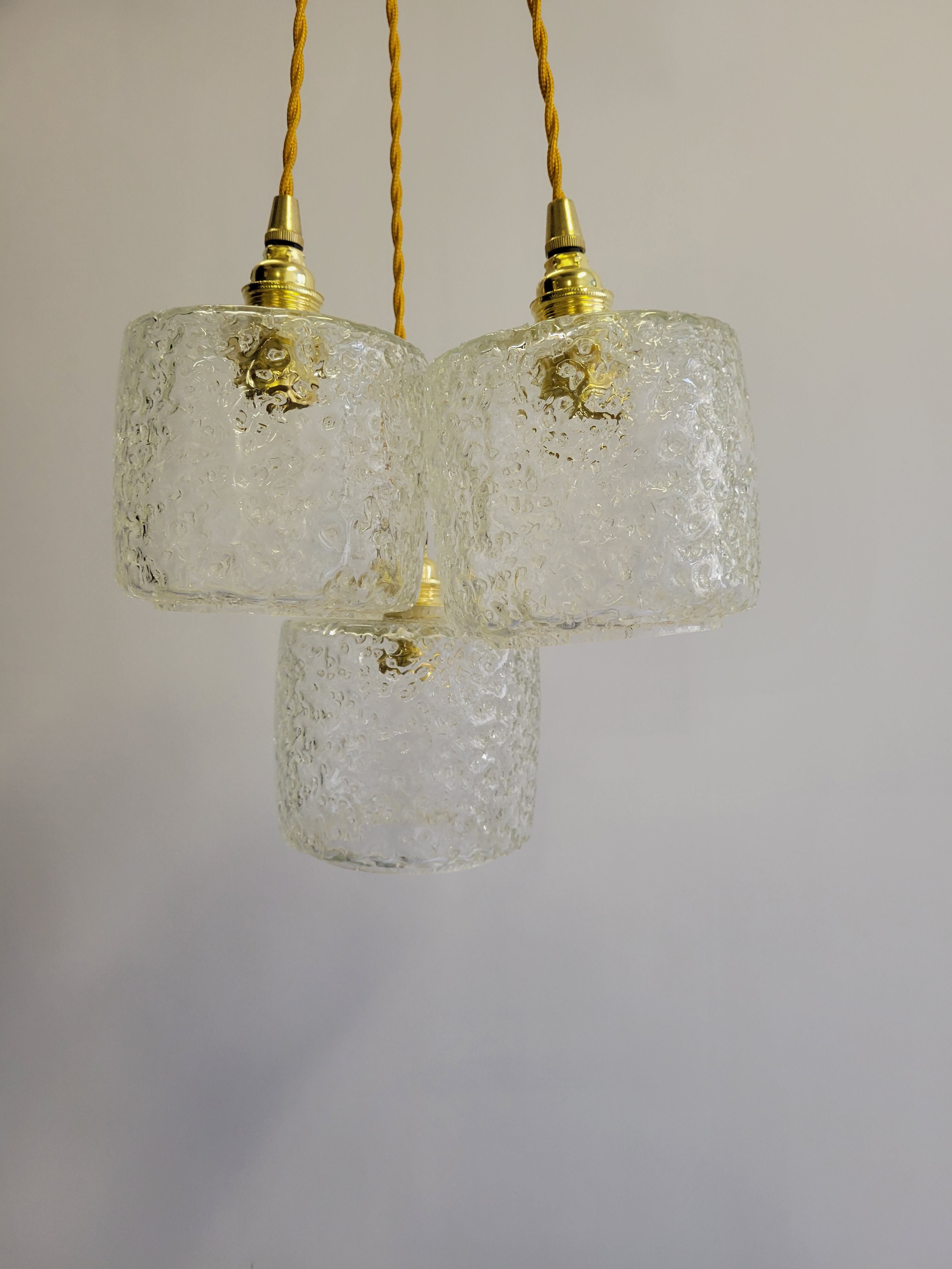 Trio of scrambled glass pendant lamps