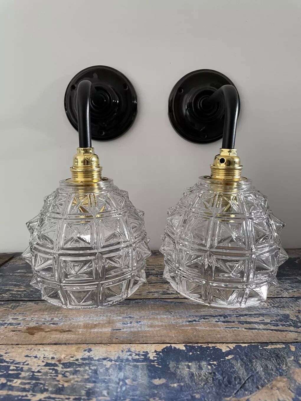 Set of two chiseled glass sconces