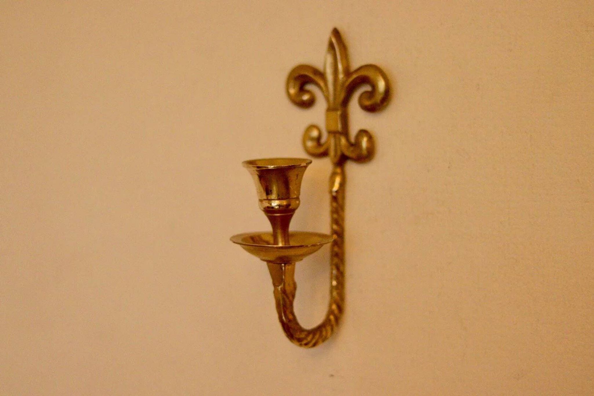 A pair of antique brass wall sconces.
