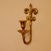 A pair of antique brass wall sconces.