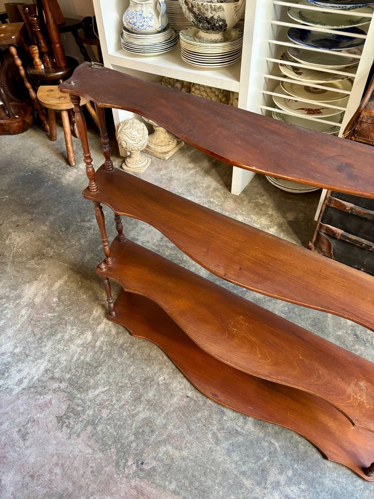 Curved and turned wooden wall shelf