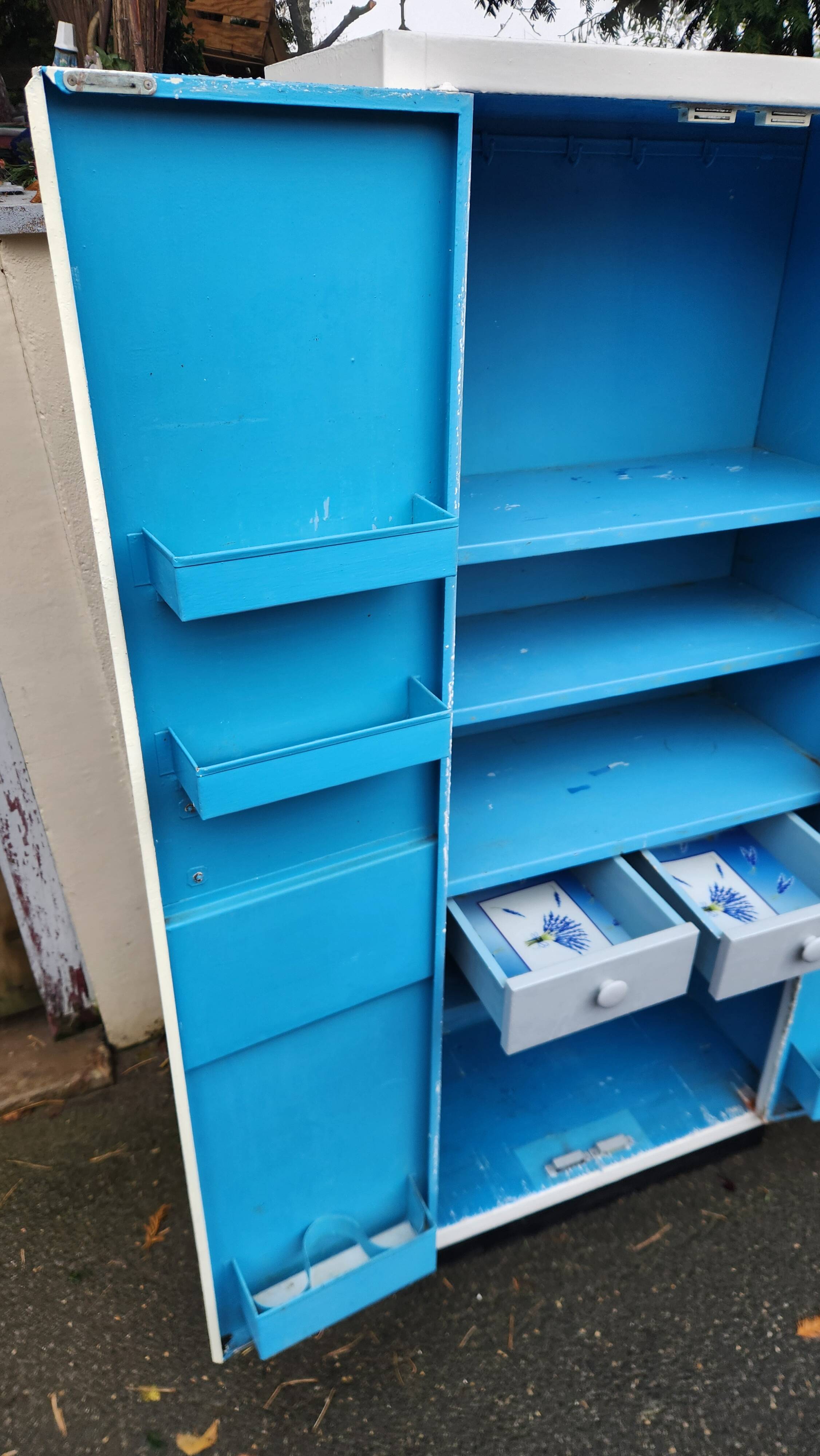 Old industrial metal cabinet in white and blue.