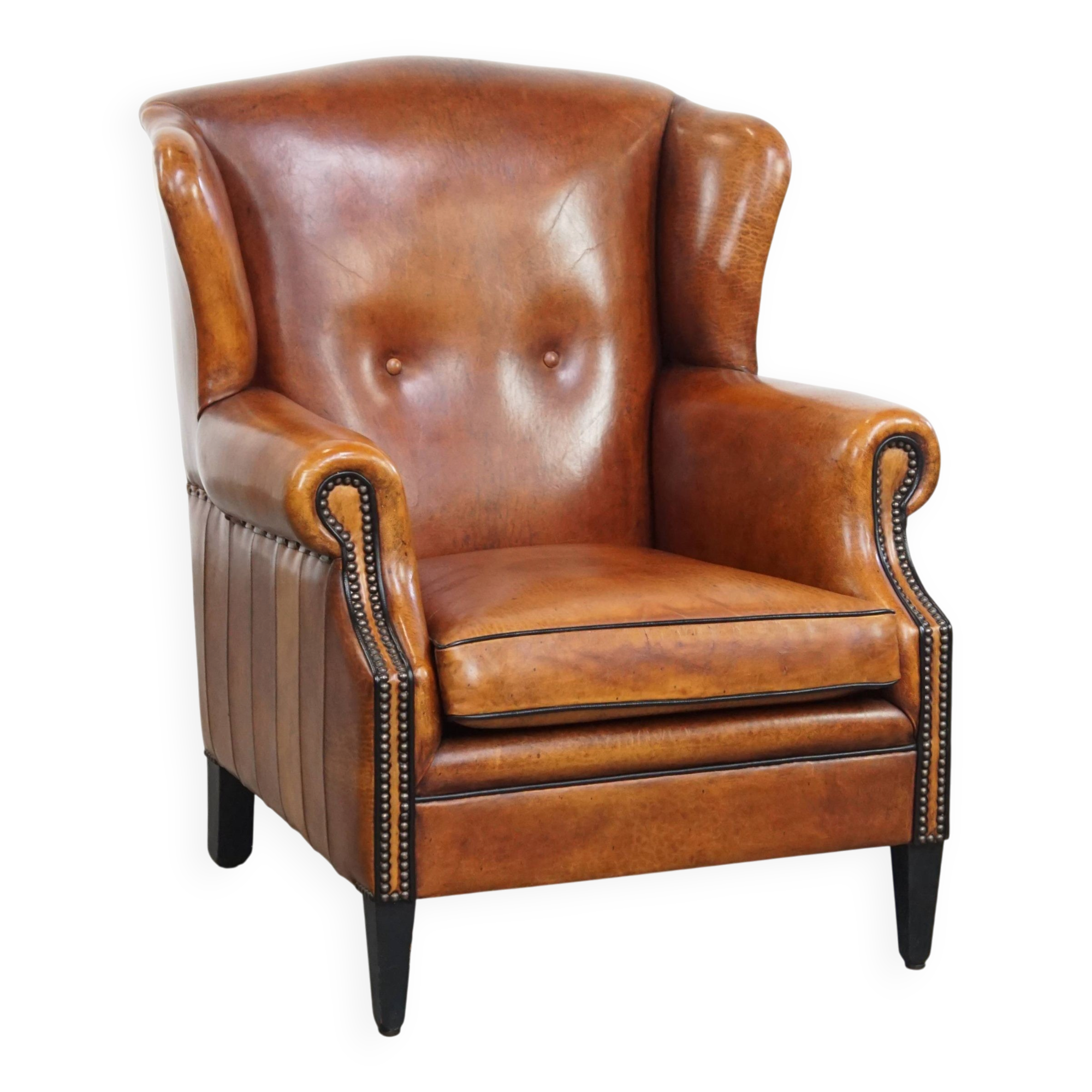 Sheepskin wingback armchair with stitching and black piping