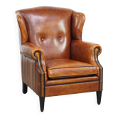 Sheepskin wingback armchair with stitching and black piping
