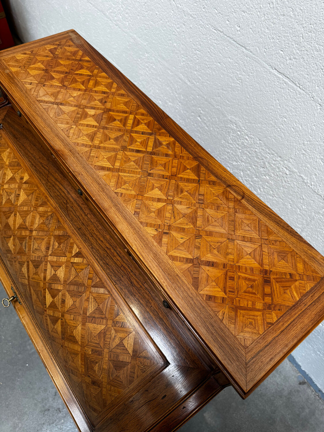 Cylinder desk with marquetry featuring a crosshatch design.