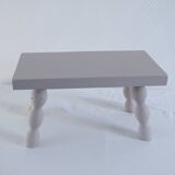 Small vintage wooden bench renovated in pinkish beige