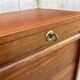 Vintage wooden filing cabinet with curtains.