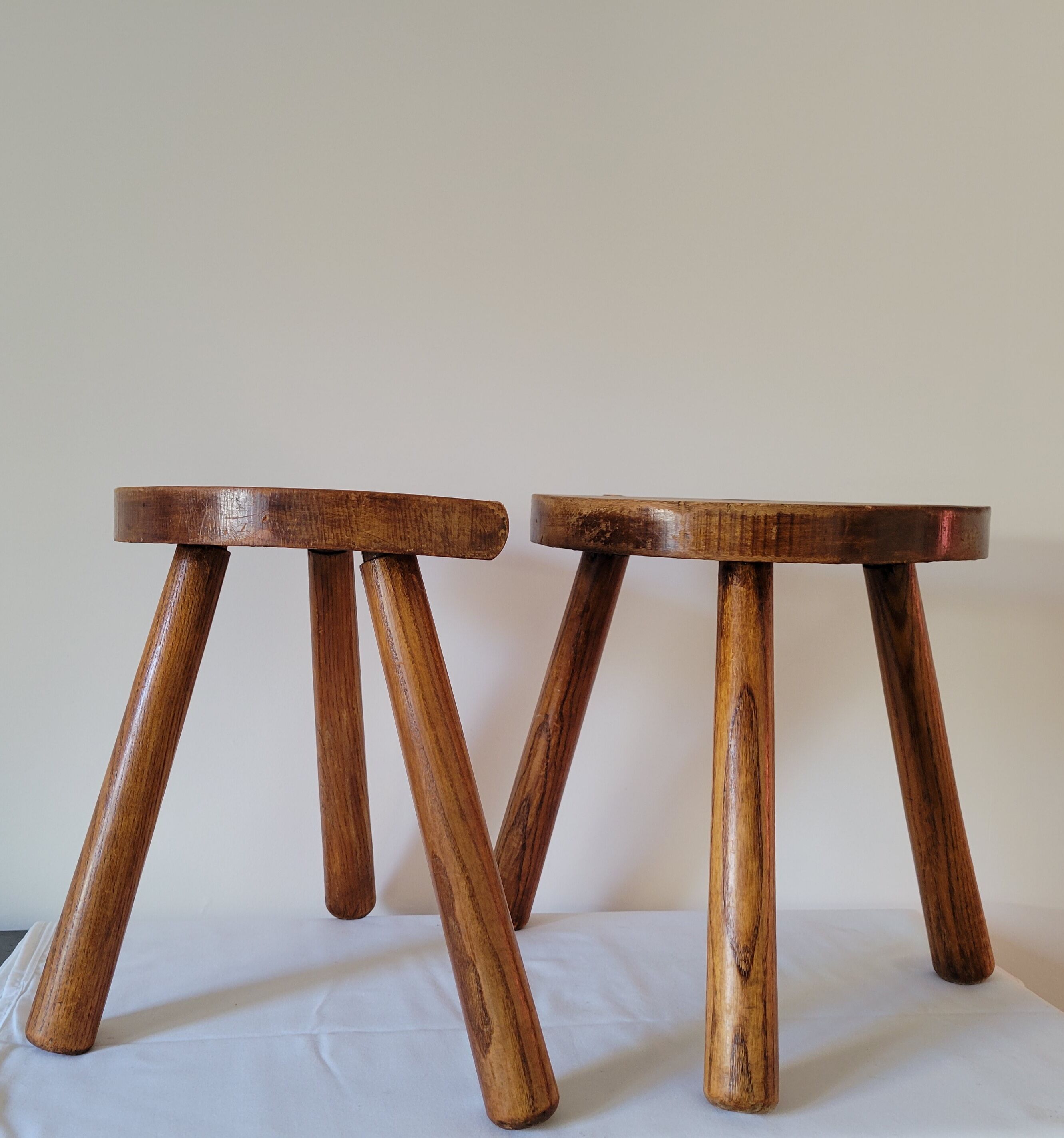 Pair of half-moon tripod stools