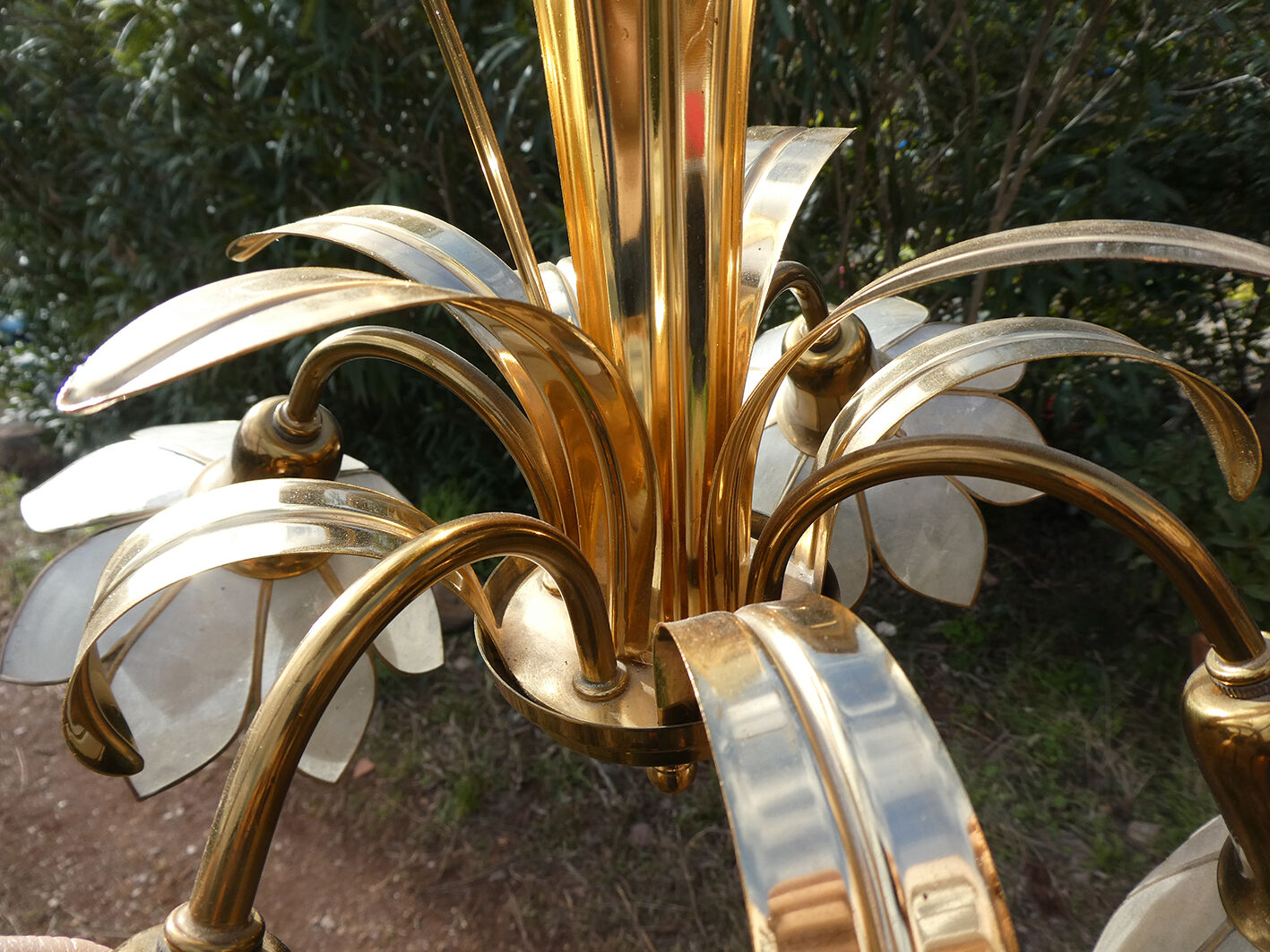 Brass chandelier and flowers in mother-of-pearl petals