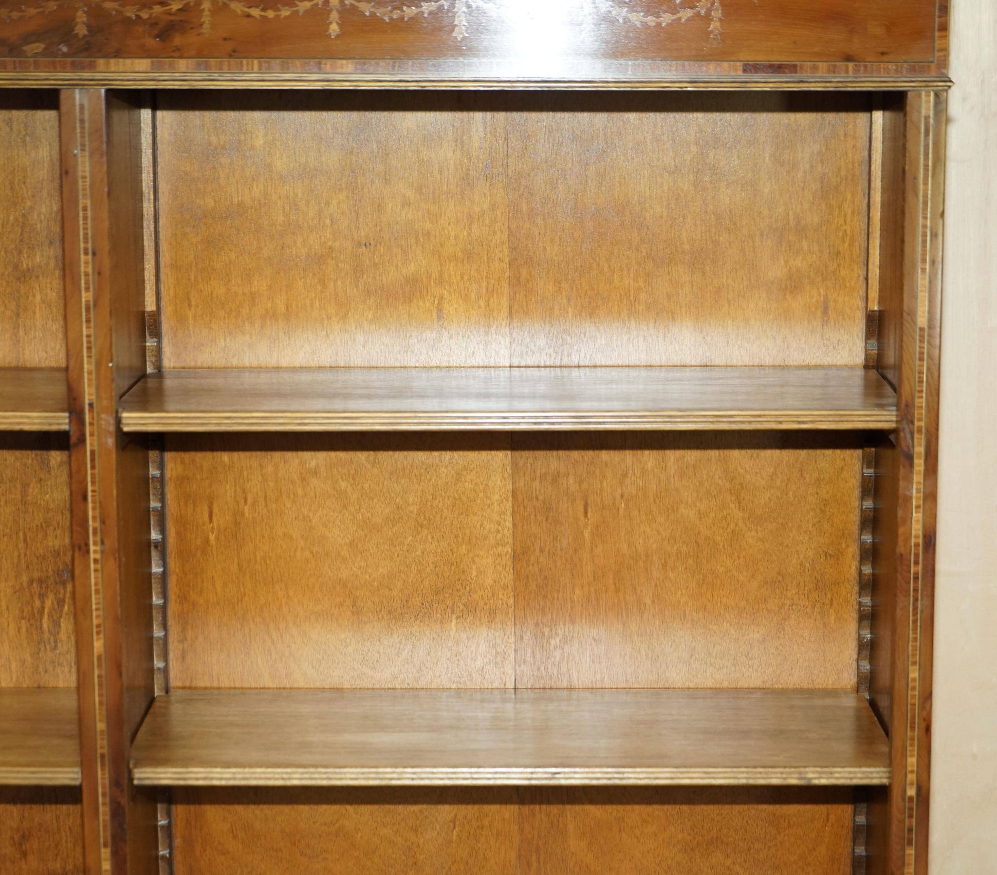Pair of Sheraton Revival bookcases in satinwood, walnut, and yew.