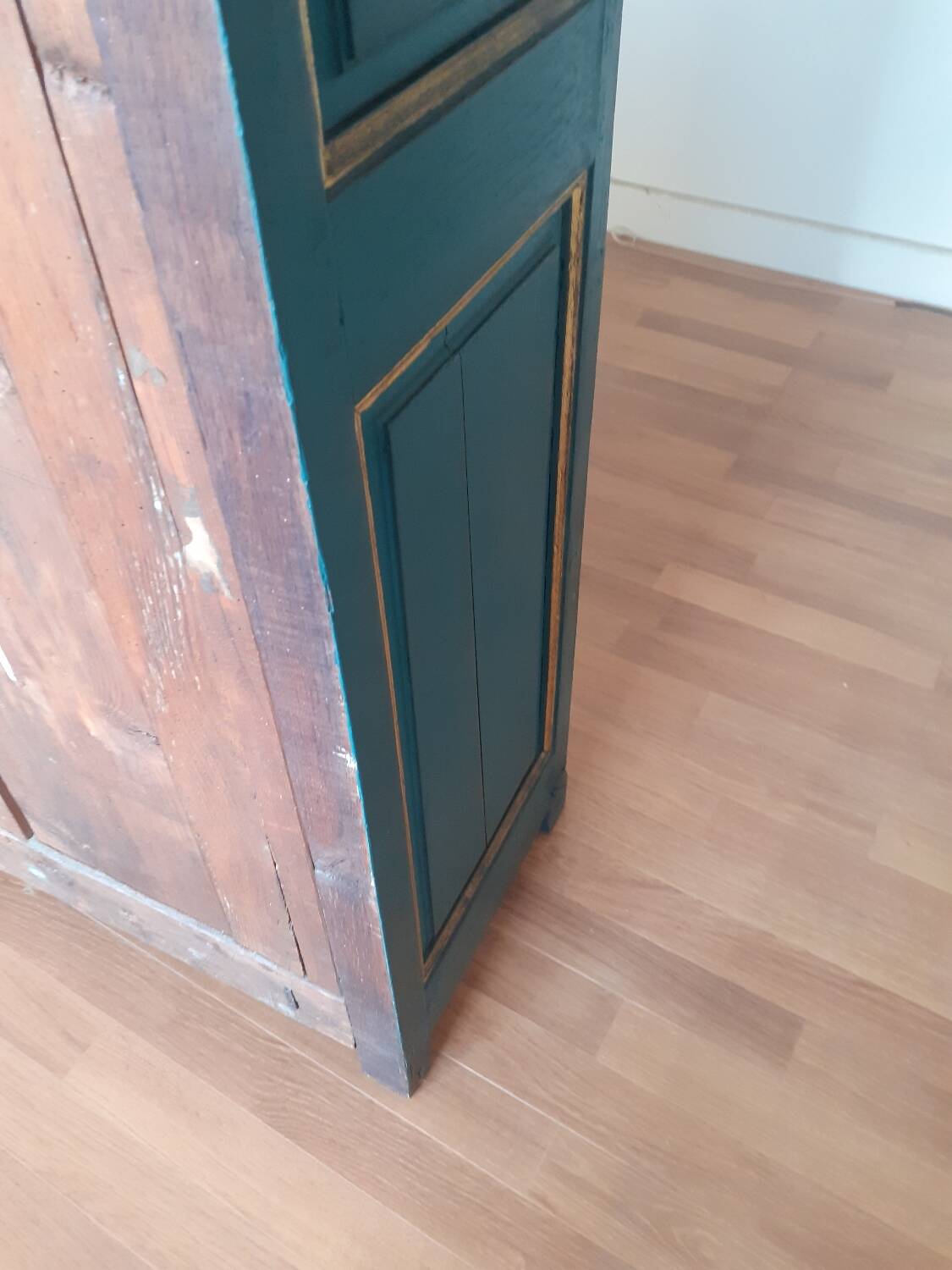 Glass-fronted cabinet in weathered green wood