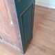 Glass-fronted cabinet in weathered green wood