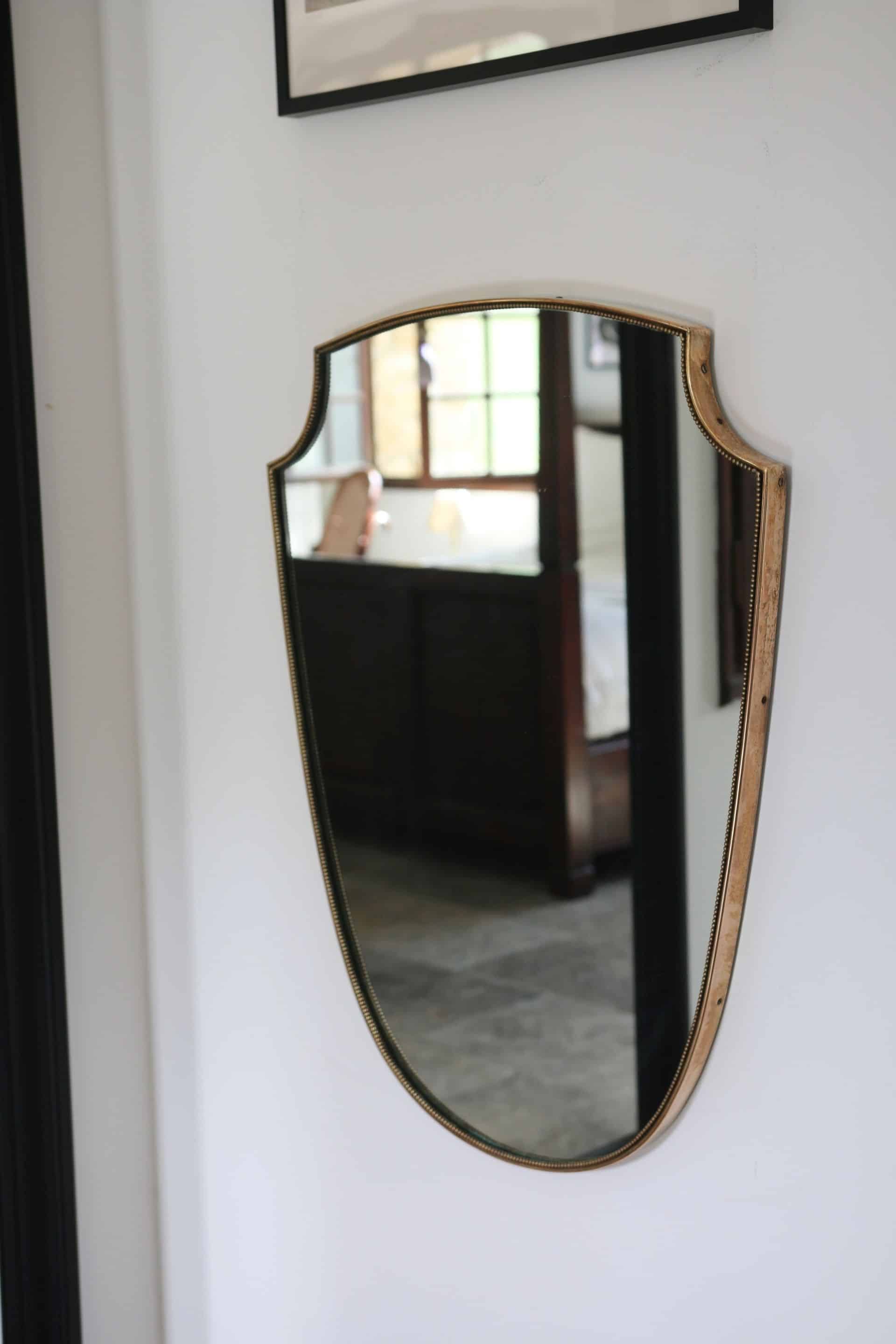 Brass mirror with crest, bead frieze, Italian design style.