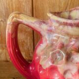 Old pitcher in burgundy ceramic