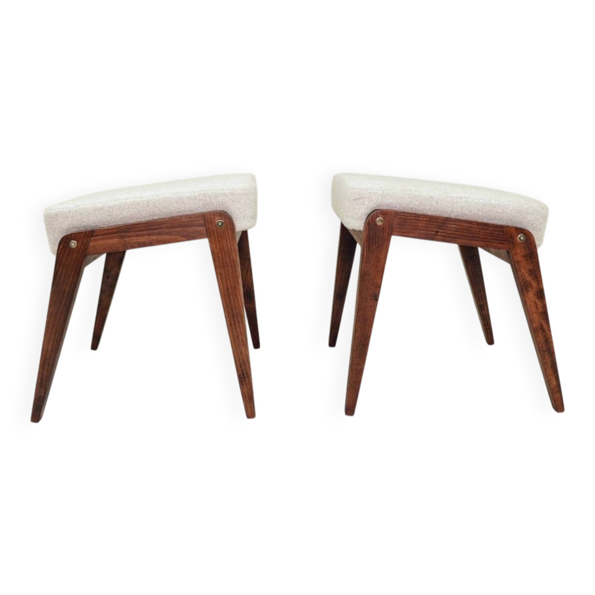 Pair of wooden stools with beige fabric.