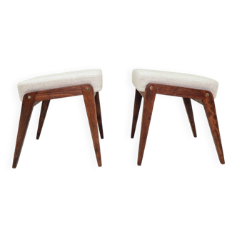 Pair of wooden stools with beige fabric.