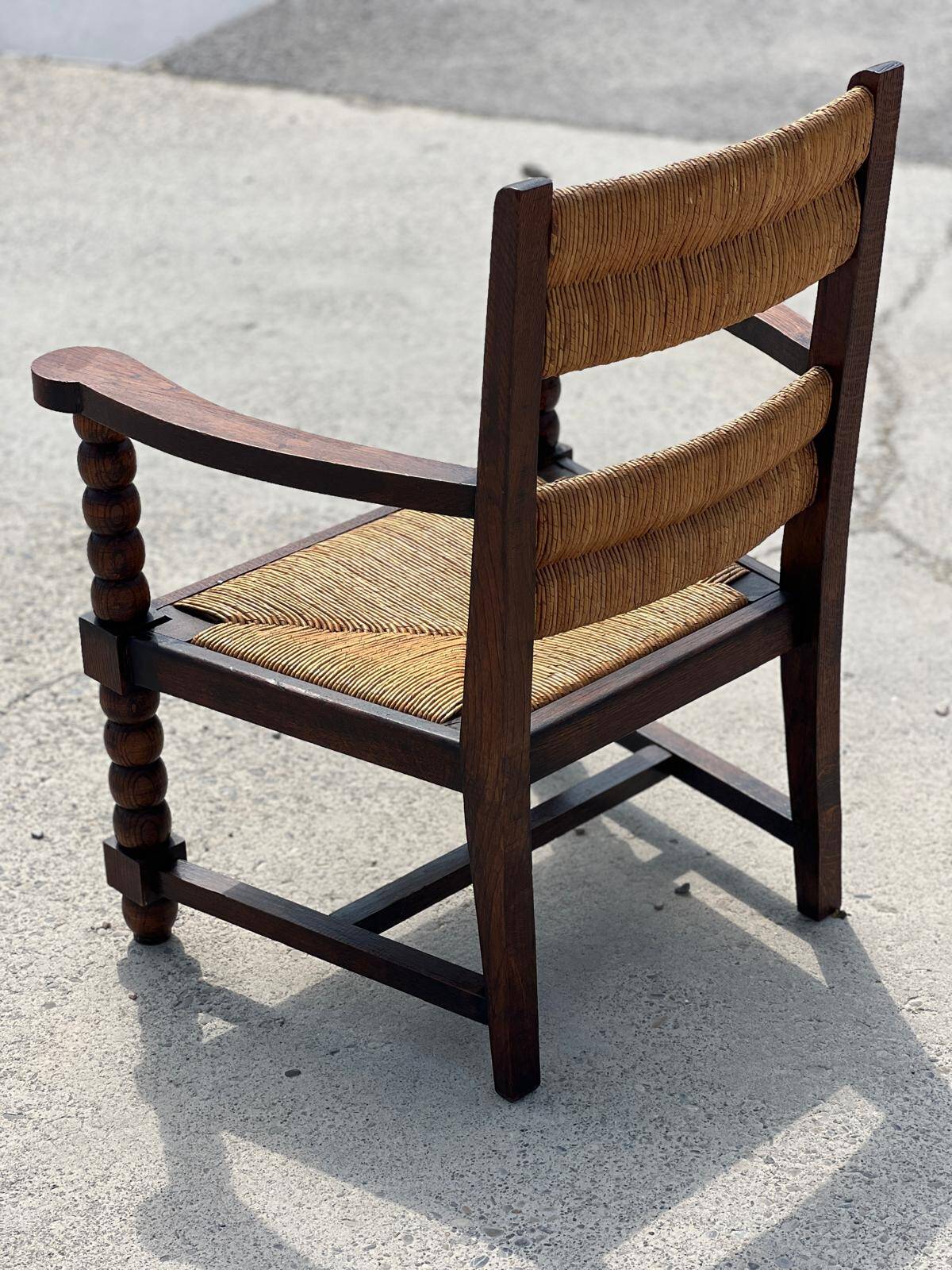 Armchair in stained oak and straw, French work from 1950.