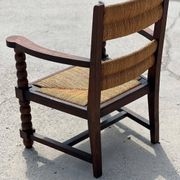 Fauteuil en  chêne teinté et paille, travail français 1950
