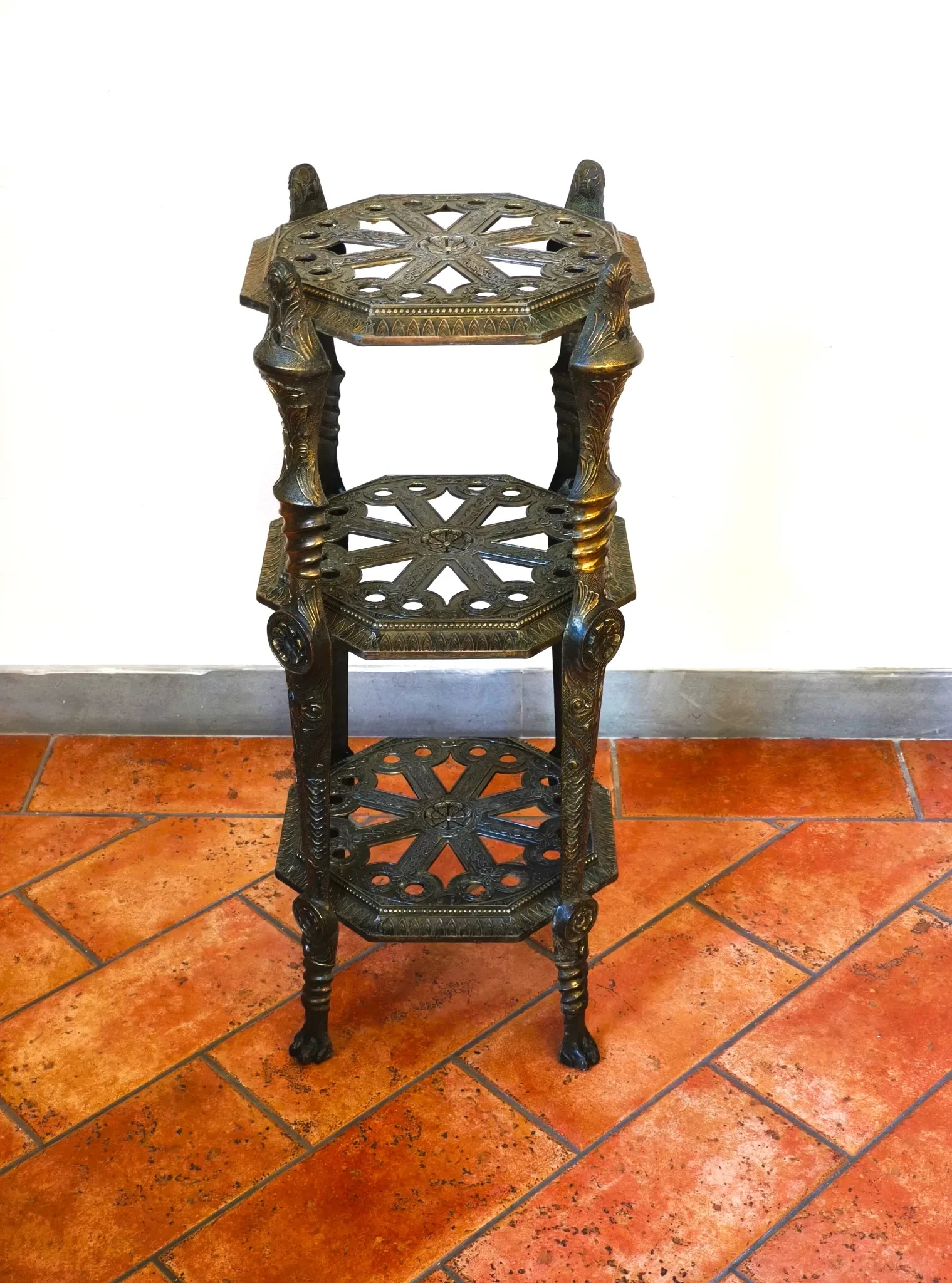 Italian side table with three openwork shelves in patinated metal.