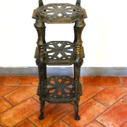 Italian side table with three openwork shelves in patinated metal.