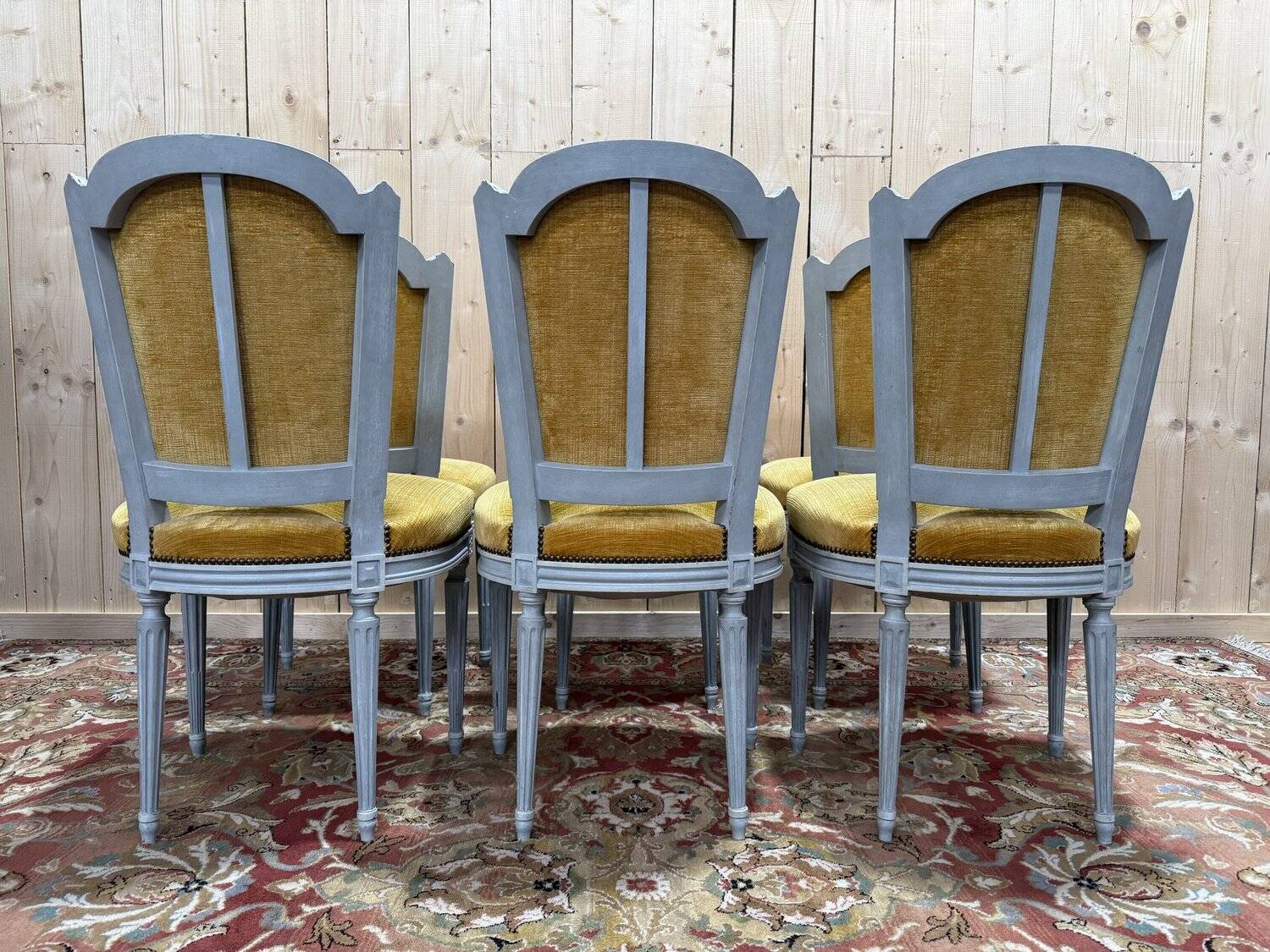 Set of 6 Louis XVI style chairs with polished wood and velvet.