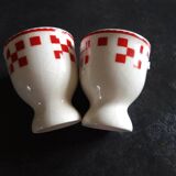 2 white egg cups with red tiles