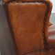 Sheepskin wingback armchair with stitching and black piping