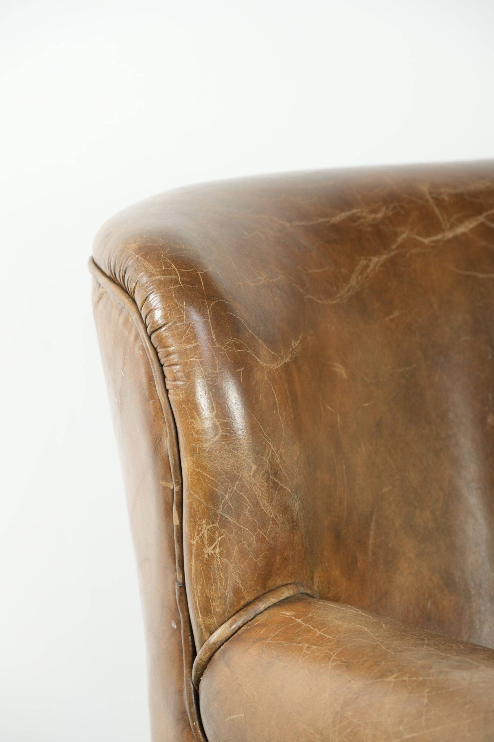 Robust cowhide armchair in a beautifully subtle size with a wonderful patina.