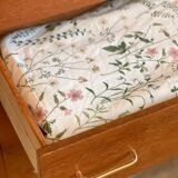 Vintage 1960s chest of drawers with covered handles.