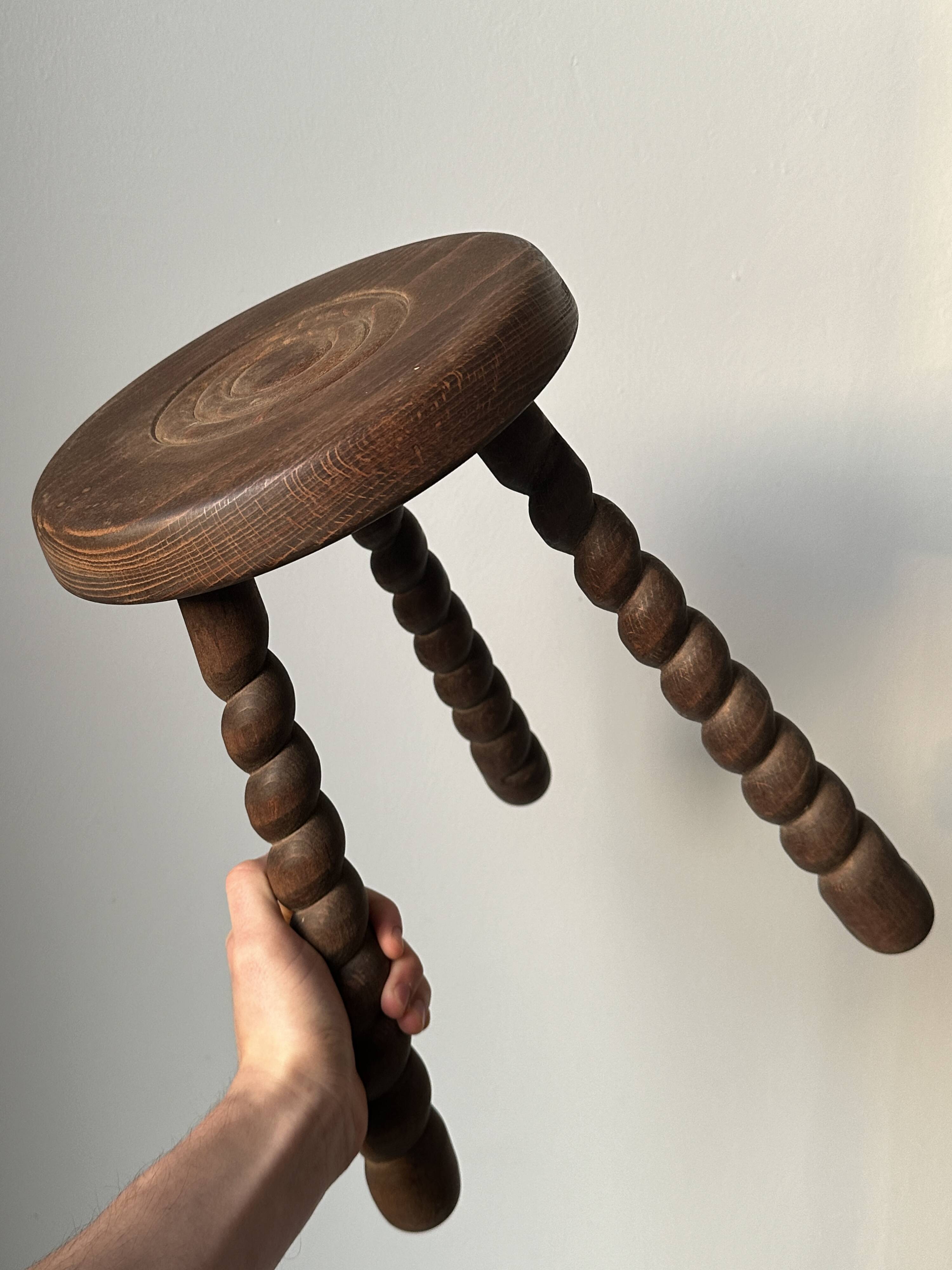 Wooden stool with three twisted legs