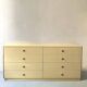 Commode type sideboard with 8 drawers, ivory lacquer and brass details, 1970s design.
