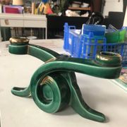Art Deco candlestick in green and gold earthenware.
