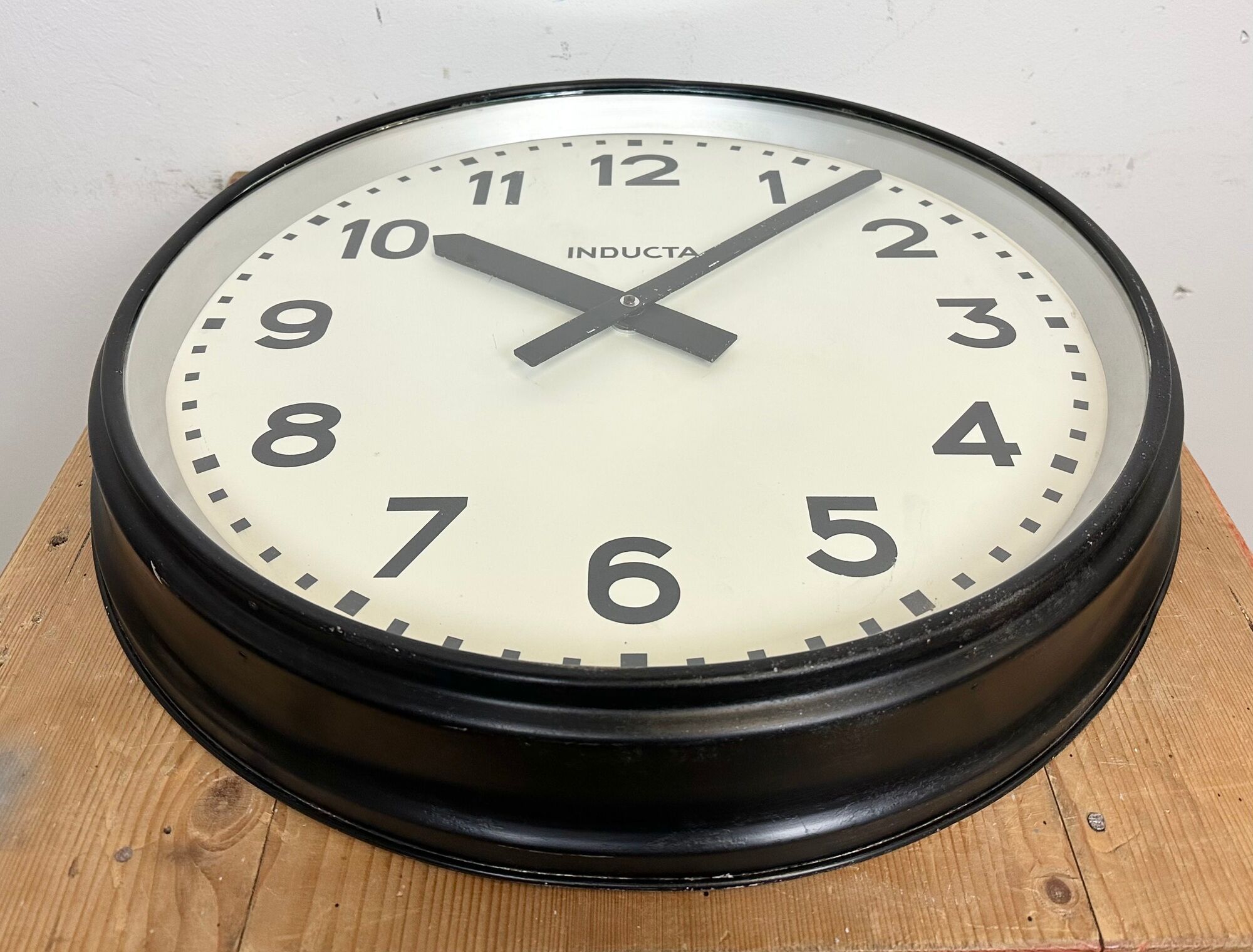 Black swiss industrial wall clock from inducta, 1960s