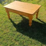 Solid oak coffee table with turned legs.