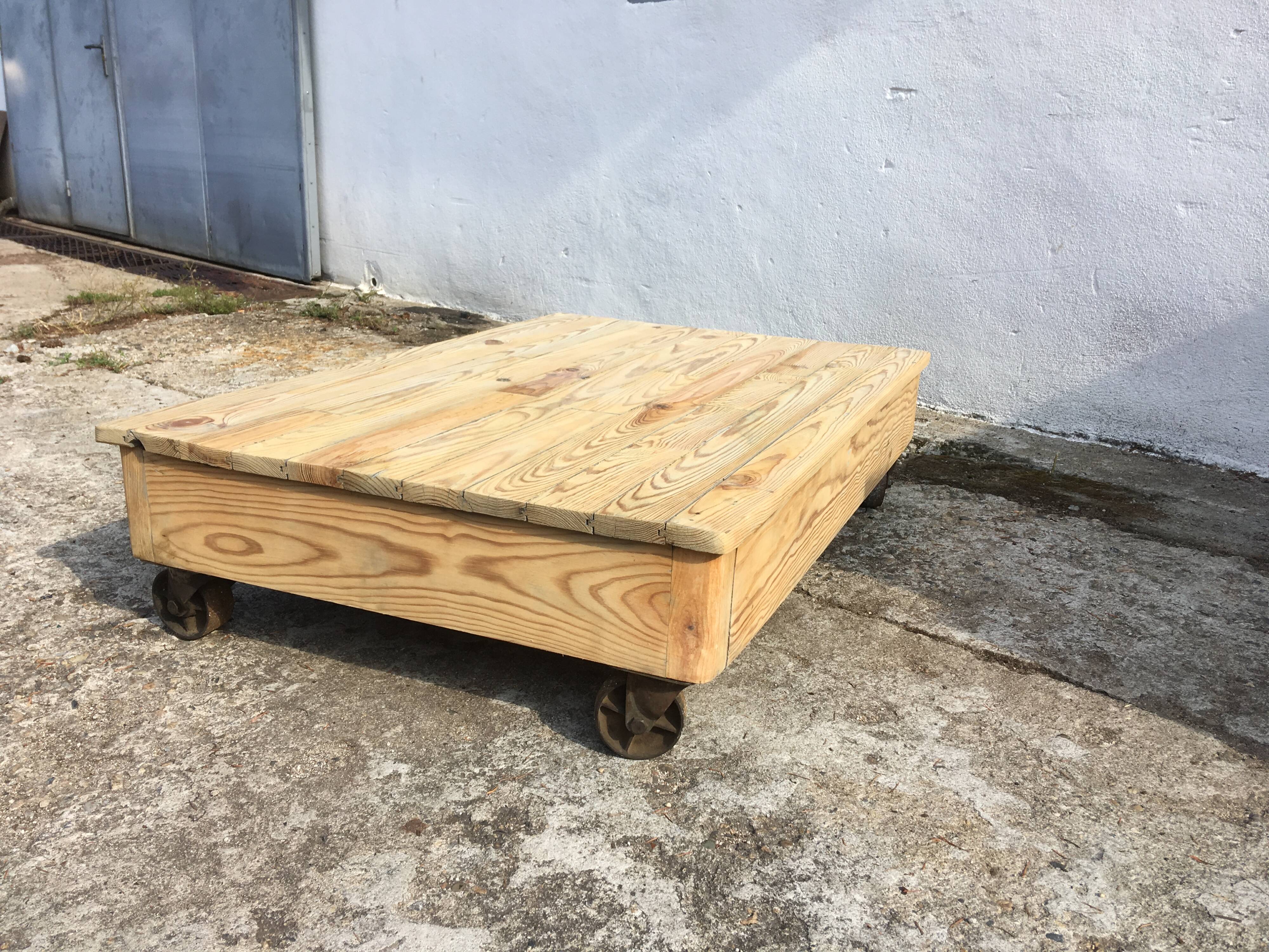 Old wooden school platform bass table on metal wheels