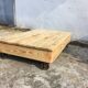 Old wooden school platform bass table on metal wheels