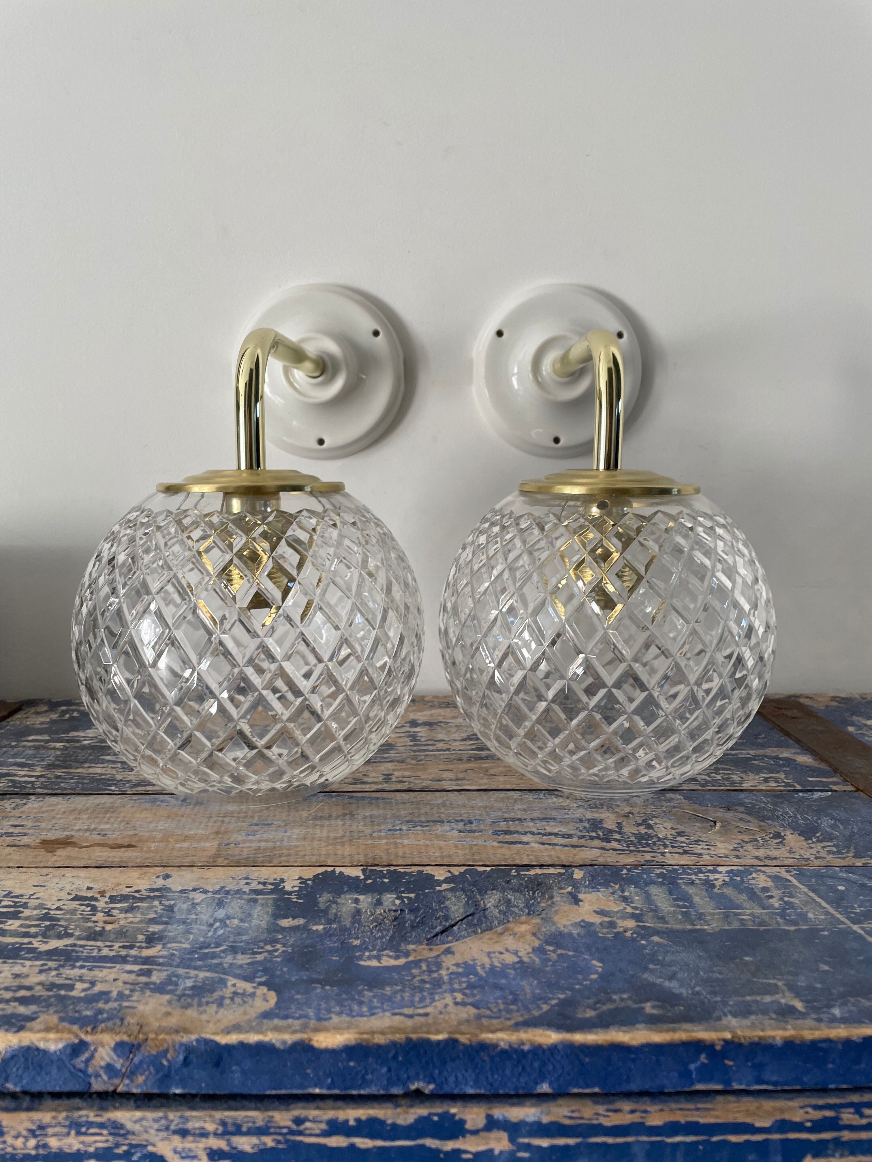 Set of two new electrified chiseled glass globe sconces