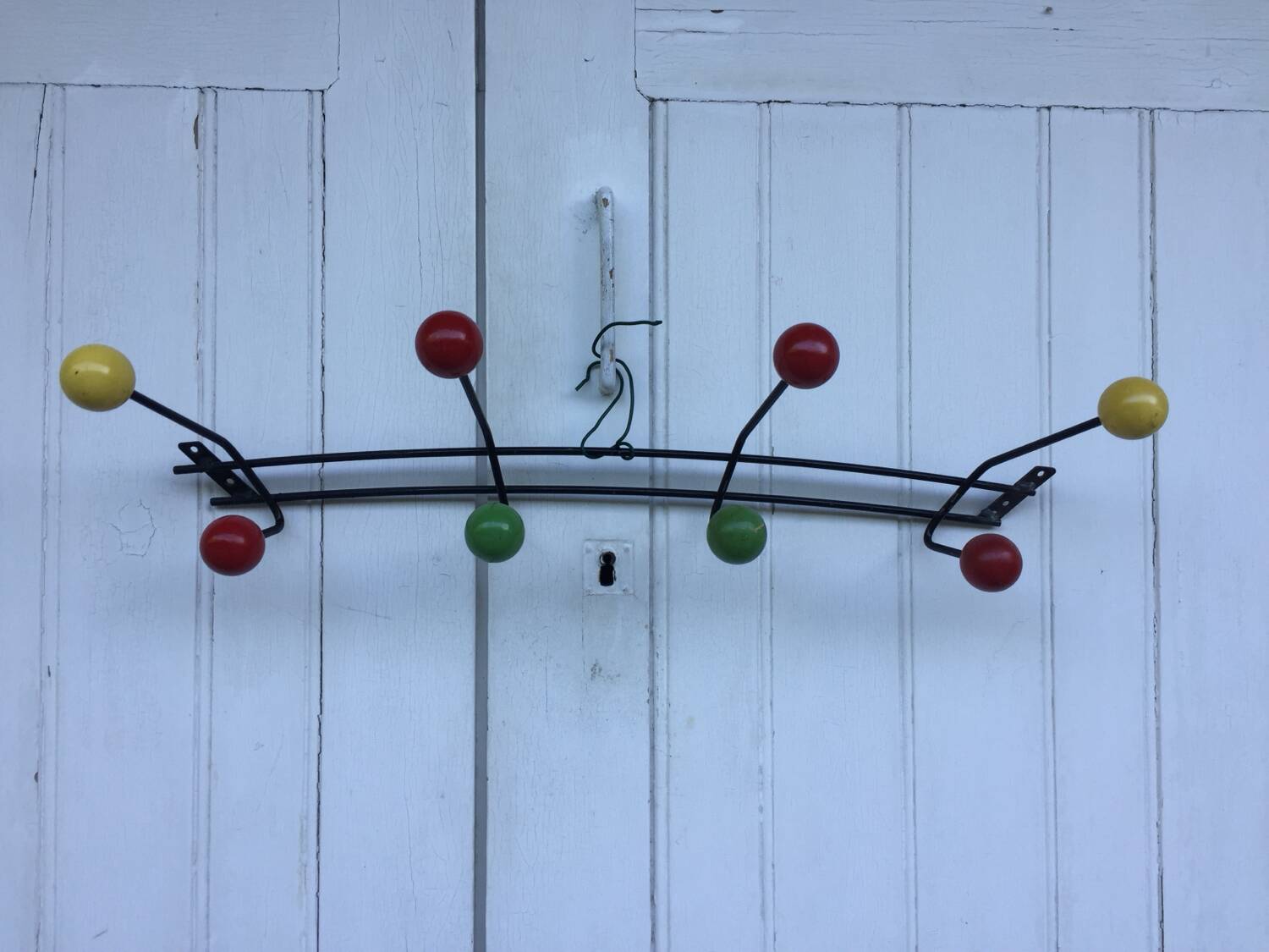 Roger Feraud wall-mounted wooden coat rack with colored balls, 1950