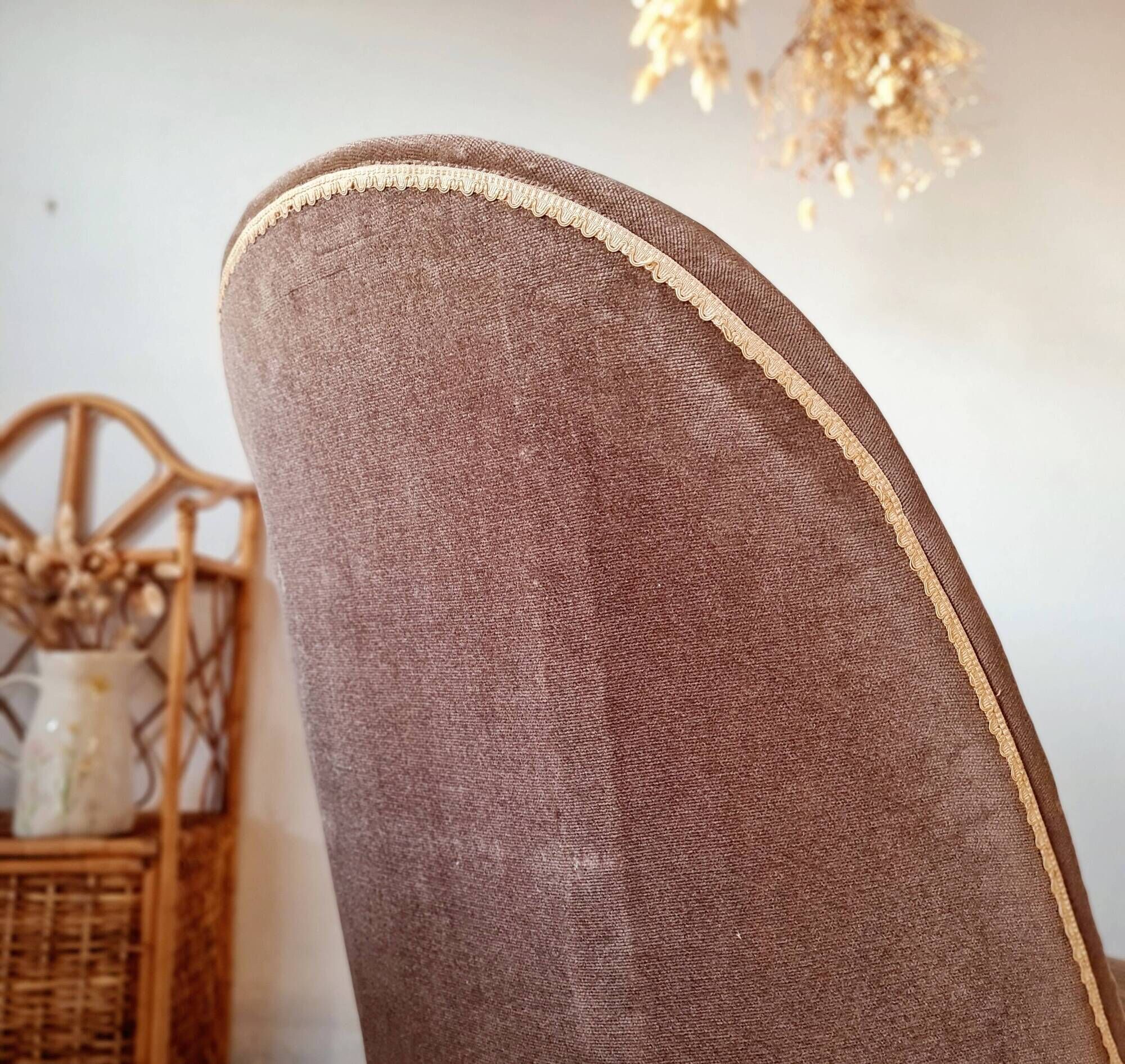 Brown velvet crapaud armchair with fringes and sculpted legs.
