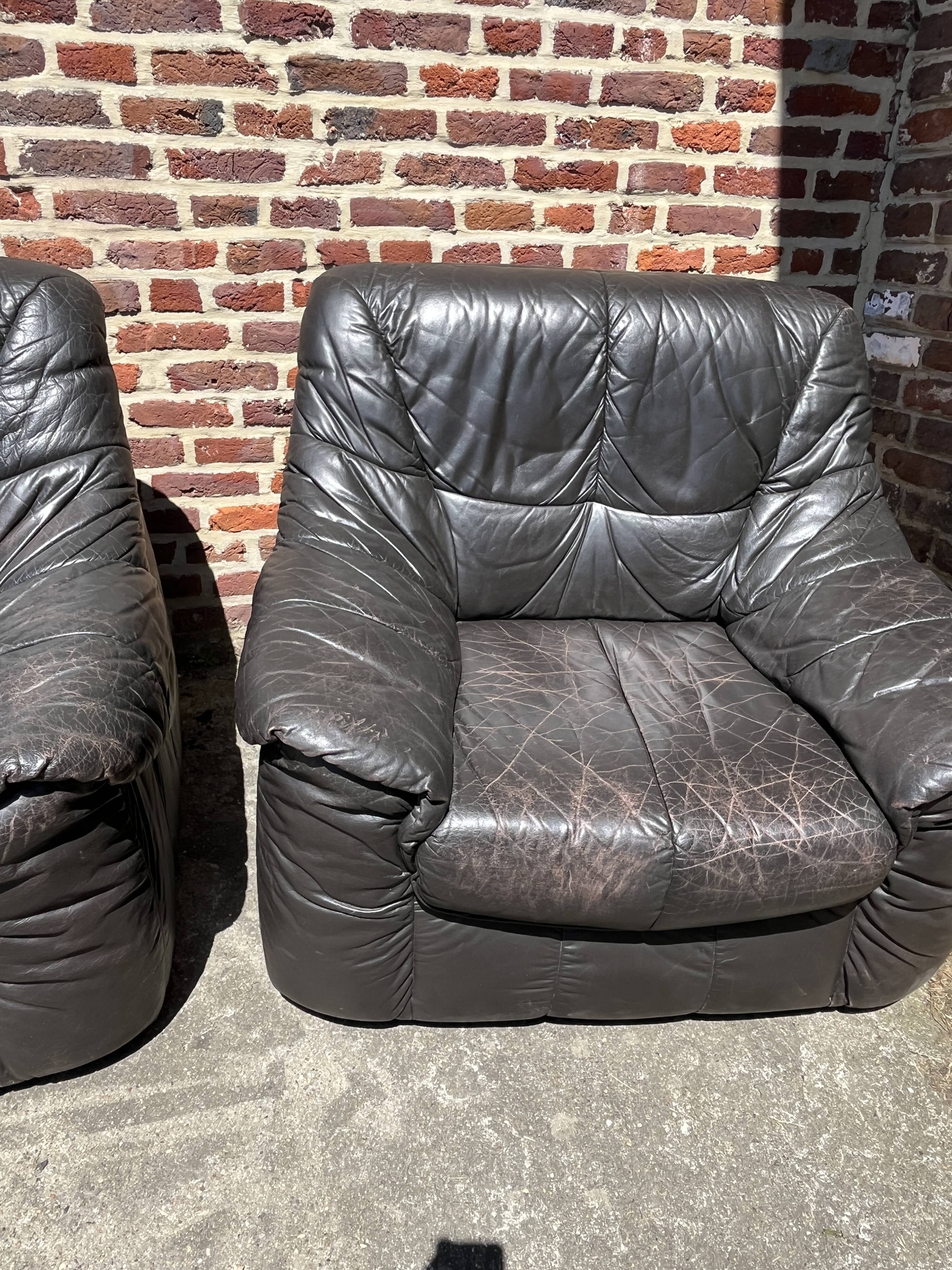 Pair of patinated leather club armchairs