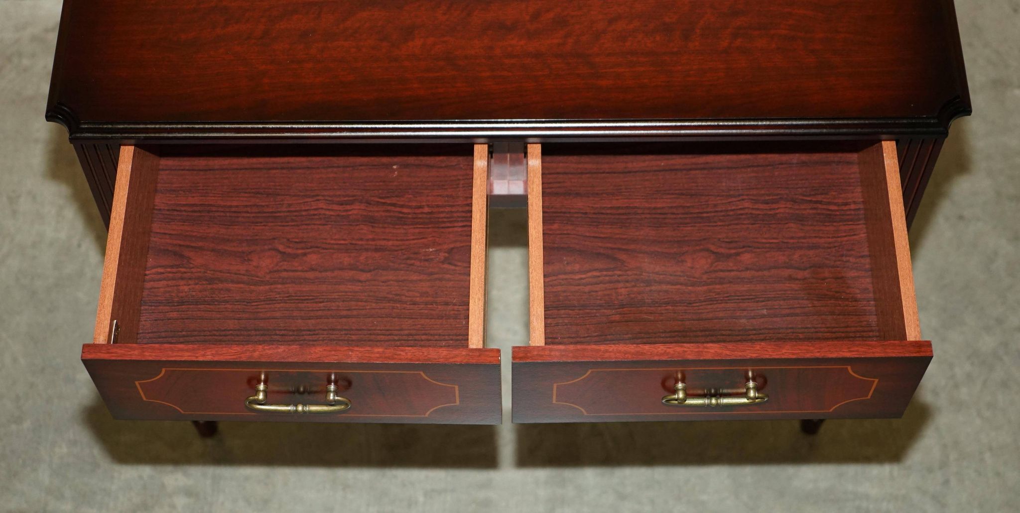 Small console with two drawers in hardwood finish.
