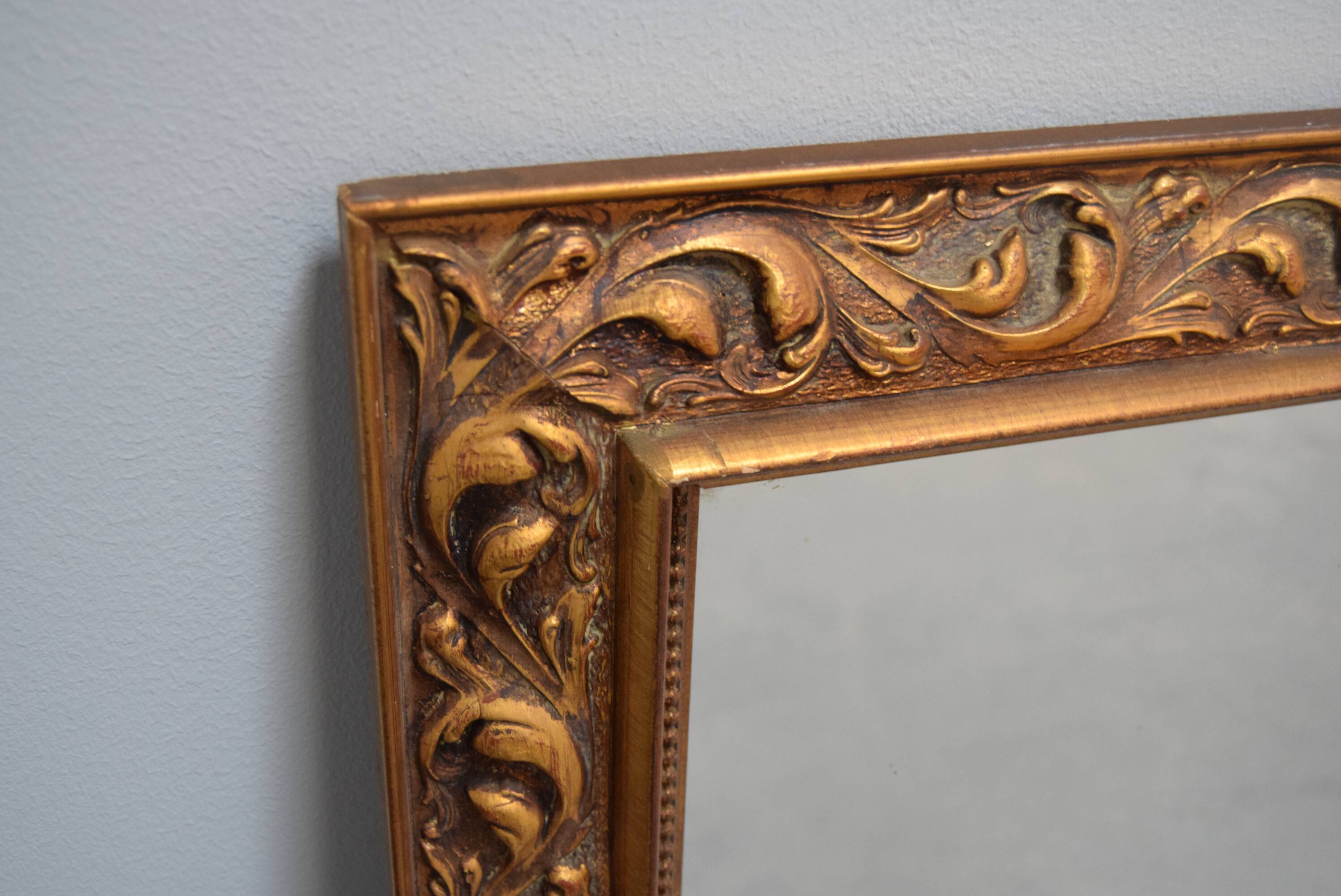 wall mirror in a decorative wooden frame.