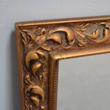 wall mirror in a decorative wooden frame.