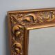 wall mirror in a decorative wooden frame.