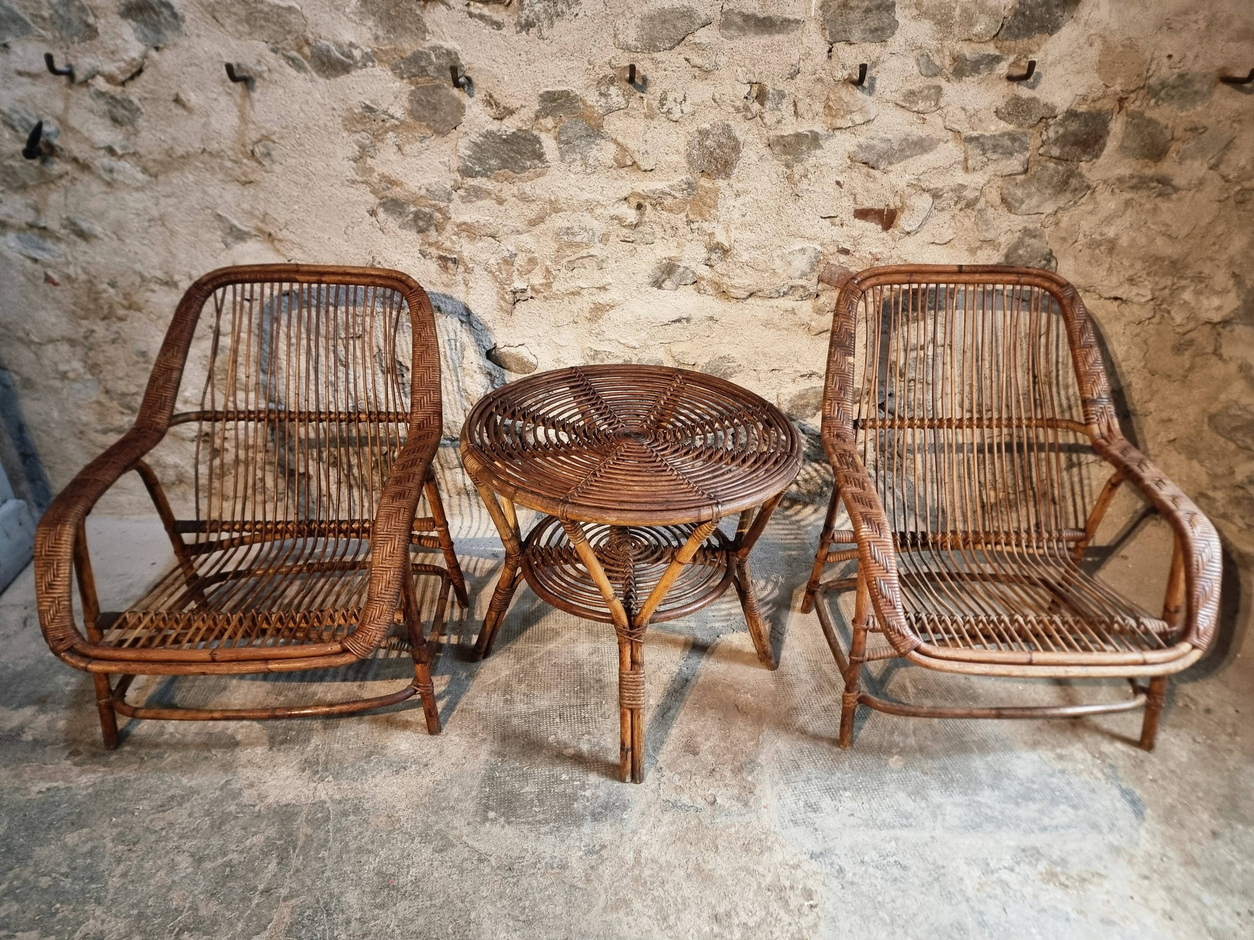 Vintage rattan lounge set, French wicker armchairs and round table, circa 1930–1950.