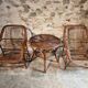Vintage rattan lounge set, French wicker armchairs and round table, circa 1930–1950.