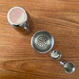 Shaker and five cocktail glasses