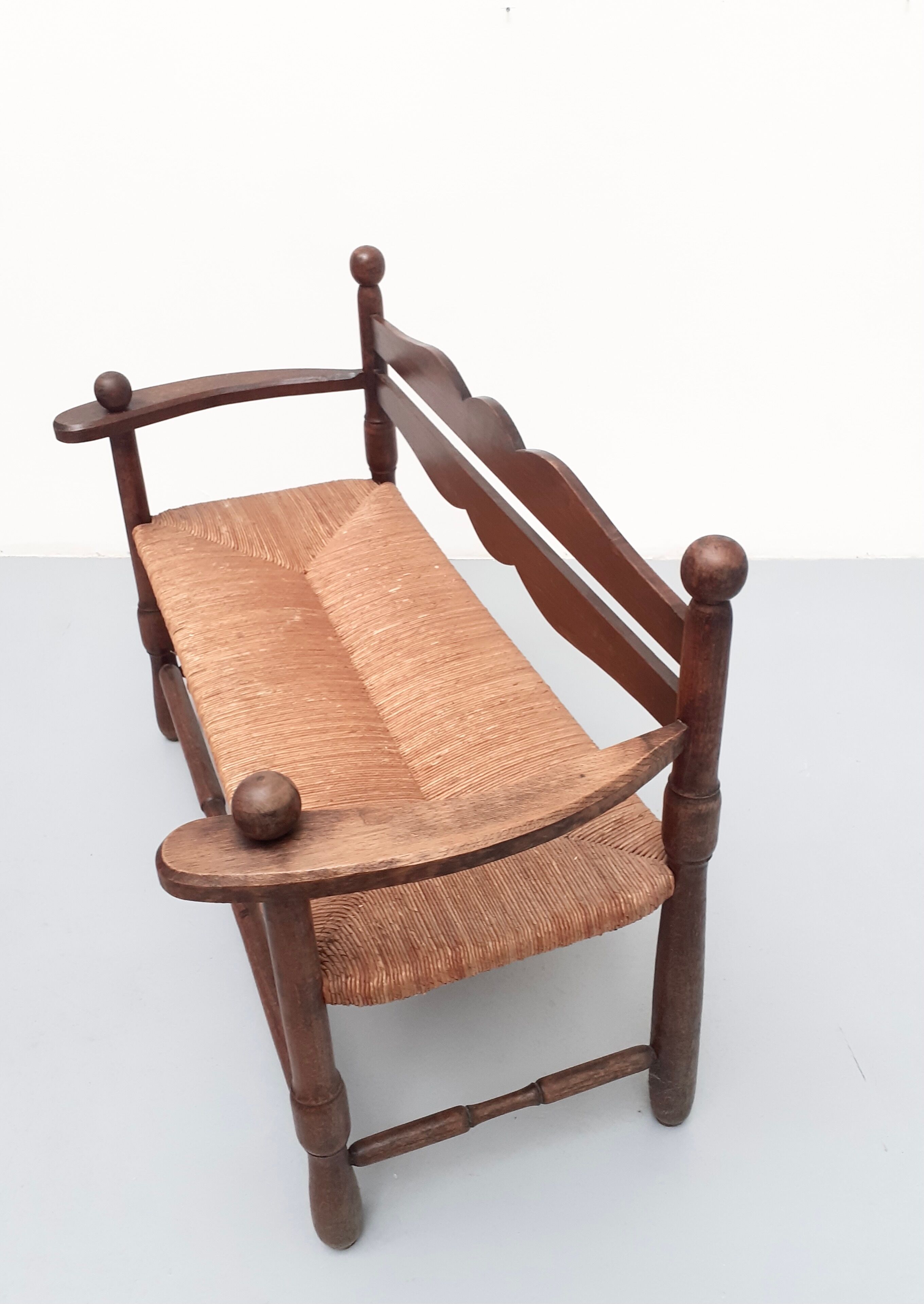 Vintage bench with wooden backrest and structure and mulched seat