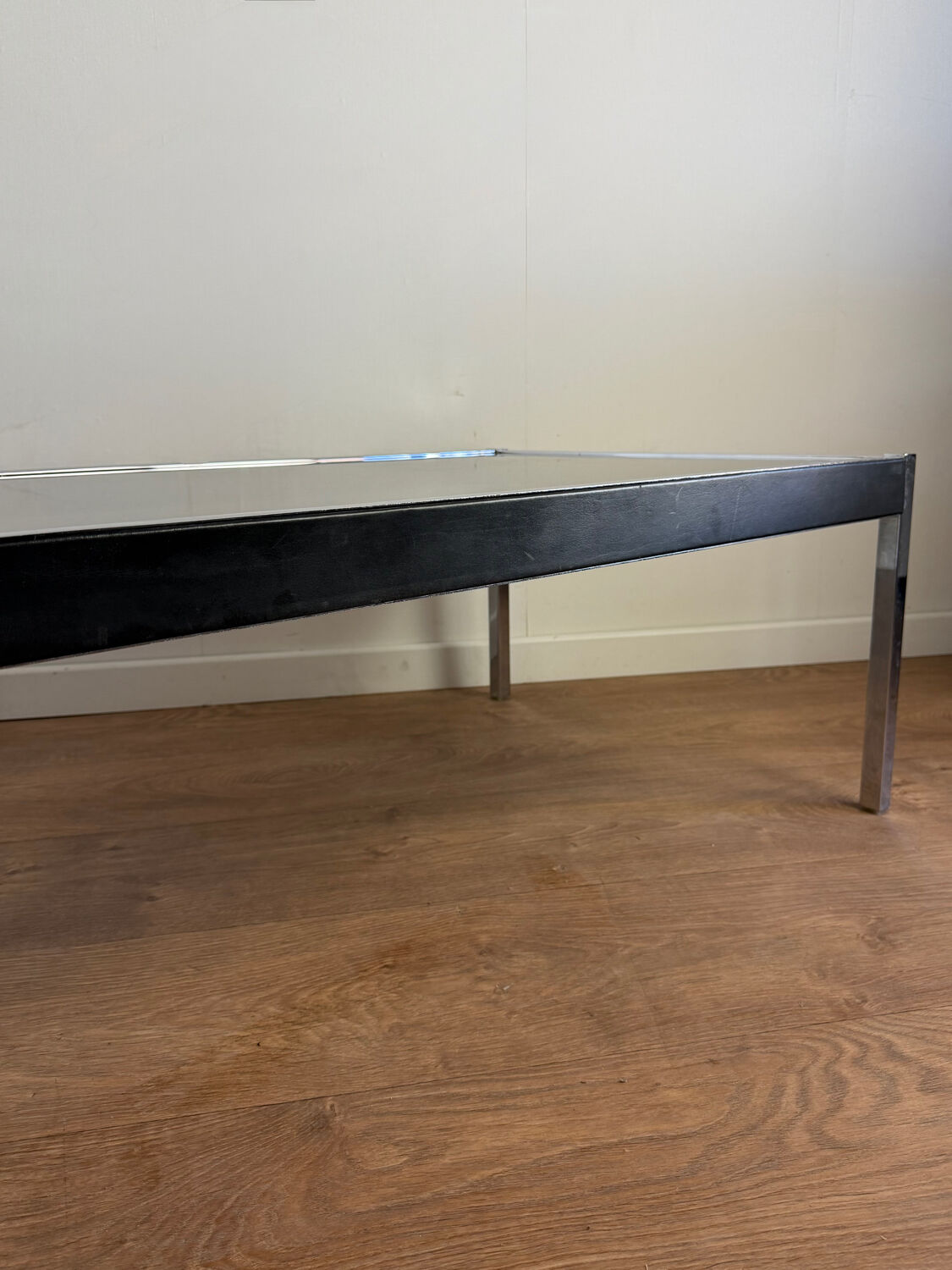 Large designer coffee table from the 70s in chrome, smoked glass, and faux leather.