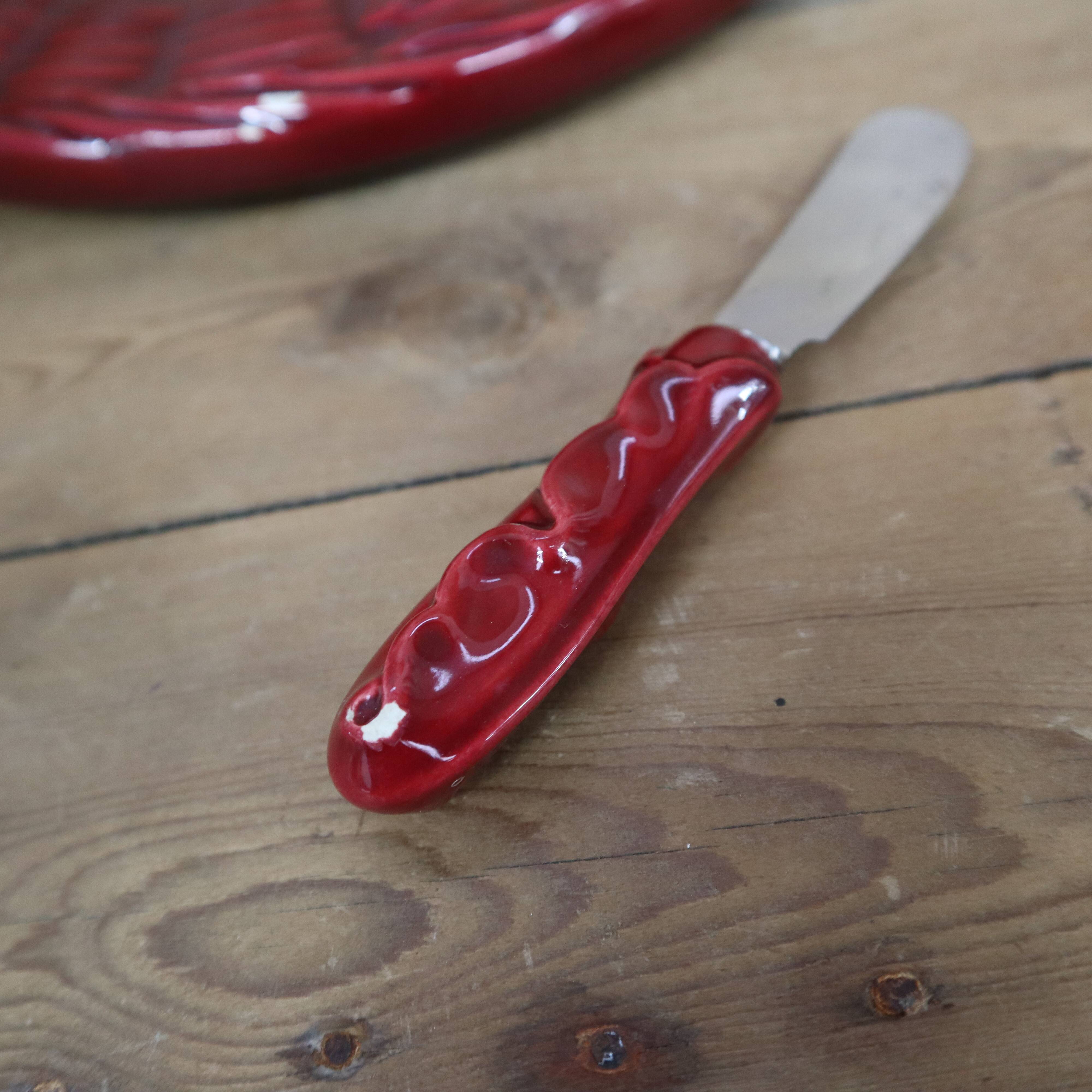 Burgundy slip tray and its small vintage knife from the 50s